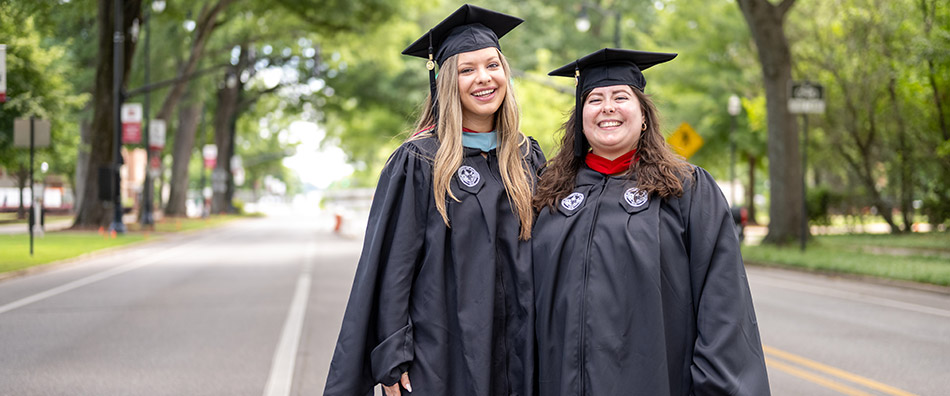 Graduates standing in University Boulevard